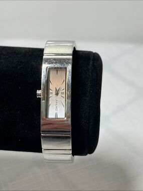 DKNY Silver Bangle Watch with Champagne-Tone Dial
Adjustable